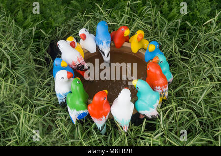 Group of colorful bird statue are meeting in garden Stock Photo