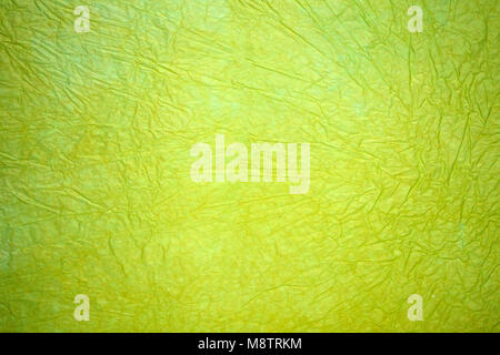 Wrinkled sheet of green paper, light neon green paper background Stock Photo