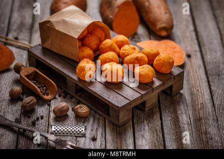 Thai fried sweet potato balls on wooden background Stock Photo