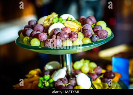 Fruit platter buffet at business or wedding event venue. Self service or all you can eat dessert with different fruit - grapes, melon, pineapple, kiwi Stock Photo