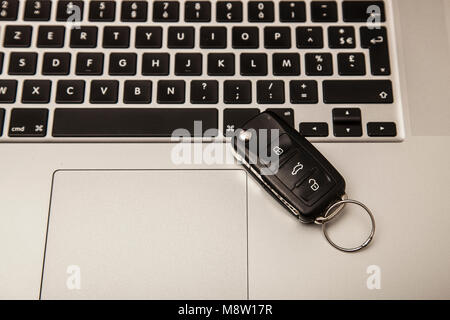 car key on the computer keyboard, vie from above Stock Photo