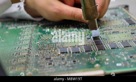 Electronic printed circuit board with many electrical components Stock Photo