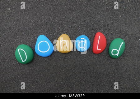 Donald, masculine name with multicolored stones over black volcanic sand Stock Photo