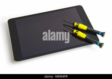 Tablet and screwdrivers. Technology service. Broken device isolated on white Stock Photo