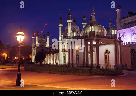 Brighton Pavilion illuminated at dusk from inside the grounds of the Royal Pavilion Garden, East Sussex, England, UK