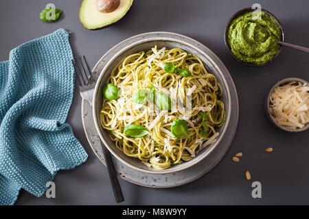 spaghetti pasta with avocado basil pesto sauce Stock Photo