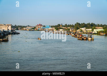 CAI BE - DECEMBER 15, 2017: Heavy loaded boats at traditional floating market on Mekong delta on december 15, 2017 in Cai Be, Vietnam. Stock Photo