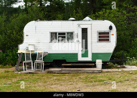 Old weathered caravan on a campsite. Monts-Valin, province of Quebec, Canada. Stock Photo