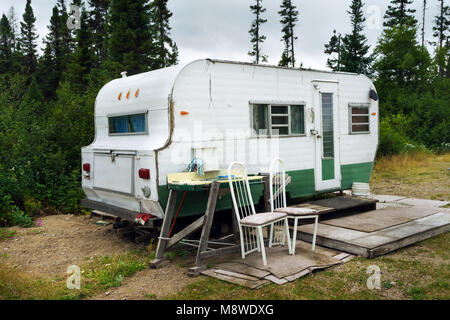 Old weathered caravan on a campsite. Monts-Valin, province of Quebec, Canada. Stock Photo