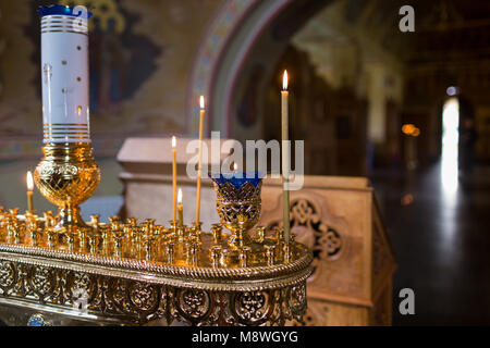 candles and lamp close-up. Interior Of Orthodox Church In Easter. baby christening. Ceremony a in Christian . bathing the into the baptismal font Stock Photo