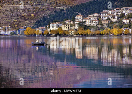 Panoramic view of Kastoria city reflected on the tranquil surface of Orestiada lake with autumn colors, in West Macedonia, Northern Greece Stock Photo