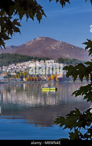 Panoramic view of Kastoria city reflected on the tranquil surface of Orestiada lake with autumn colors, in West Macedonia, Northern Greece Stock Photo