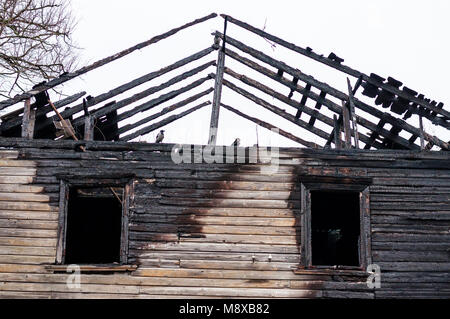 Remains of the burnt wooden house facade Stock Photo
