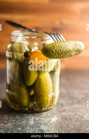 Pickles in bowl. Tasty preserved cucumbers in jar. Stock Photo