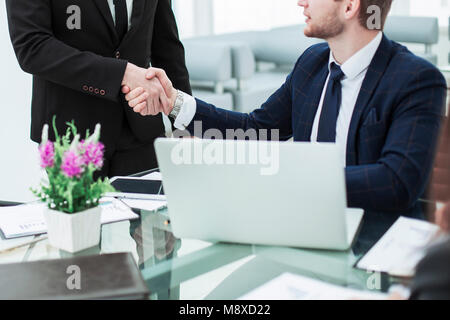 handshake between colleagues in the workplace in a modern office Stock Photo