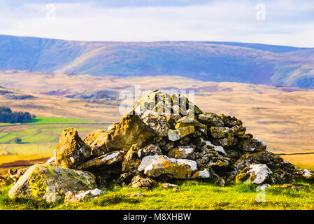 Cairn on Crosby Ravensworth Fell in the Yorkshire Dales National Park Cumbria with Kidsty Pike and High Street on the horizon Stock Photo