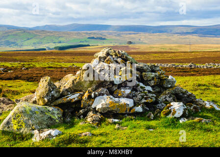 Cairn on Crosby Ravensworth Fell in the Yorkshire Dales National Park Cumbria with Kidsty Pike and High Street on the horizon Stock Photo