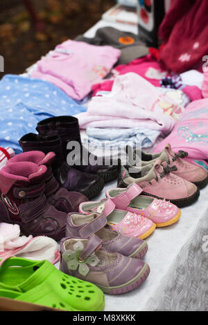 Flea market stall with beautifull second hand children's clothing Stock Photo