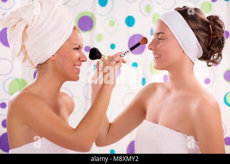 Two young cute woman having fun and get ready to start their day. Stock Photo