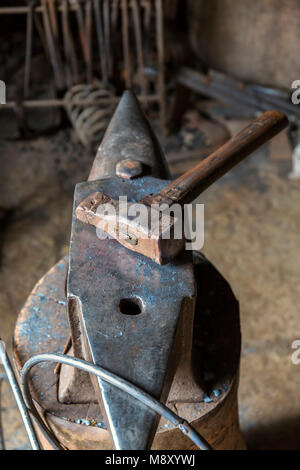 Old Sledge on an anvil in a workshop Stock Photo