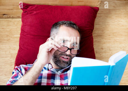 portrait of handsome bearded man reading a book Stock Photo