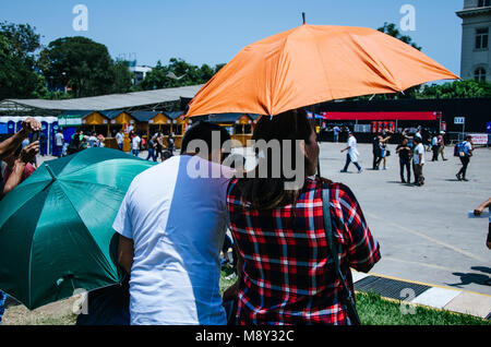 A couple with an umbrella protecting themselves from the sun Stock Photo