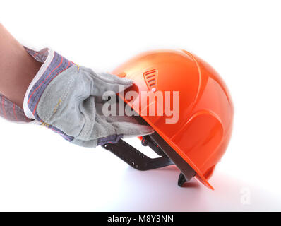 worker in protective gloves holds an orange hard hat in his hand. Safety helmet. Stock Photo