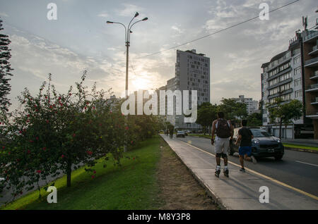Skater and runner through the streets of Miraflores Stock Photo