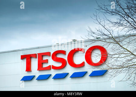 A sign for Tesco on the side of a building. Stock Photo