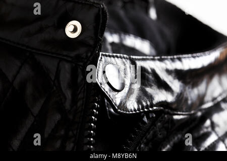 Macro shot of black leather jacket focusing on zipper and stud Stock Photo