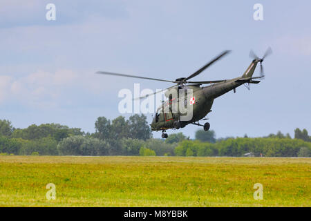 The Polish Air Force PZL W-3 Sokol (Falcon) flying over meadow during International Air Show at the 90th Jubilee of The Polish Air Force Academy. Stock Photo