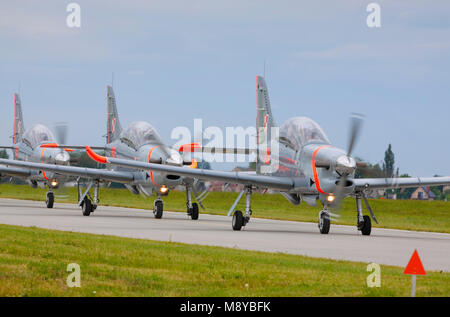 The Polish Air Force Orlik Aerobatics Team parade on runway during International Air Show at the 90th Jubilee of The Polish Air Force Academy. Stock Photo