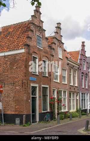 Unique stepped gable roofs in medieval street in the Netherlands Stock Photo