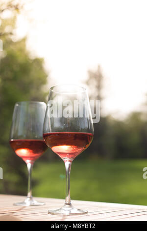 Two glasses of rose wine on an outdoor table Stock Photo