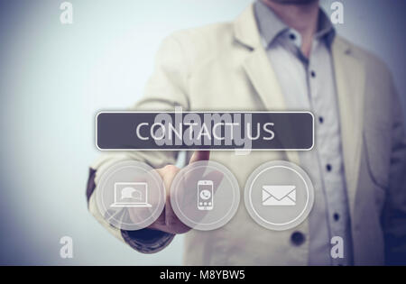 Businessman Pushing Contact Us. businessman hand pushing contact us button on a touch screen interface. Stock Photo