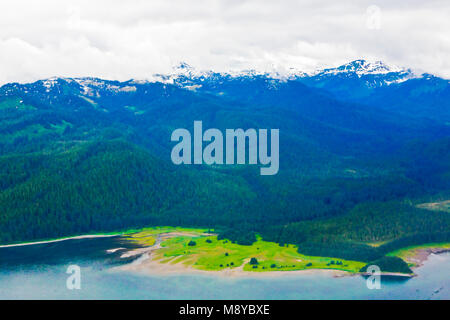 Aerial view of uninhabited areas of Alaska's forested coastline and islands. Stock Photo