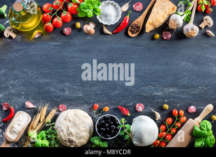Pizza Ingredients On Black Table In A Raw - Italian Food Stock Photo