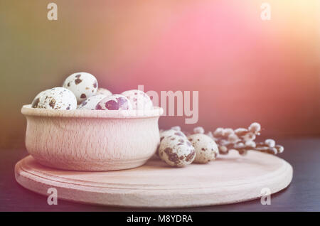 Easter card with quail eggs and willow branches on dark background with empty space. Happy Easter. Easter background with space for text. Copy space. Stock Photo