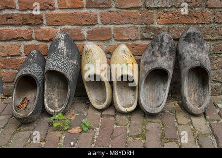 Row of wooden shoes drying against a wall in the Netherlands Stock Photo