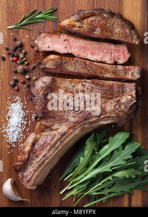 Grilled Cowboy Beef Steak, Herbs And Spices On A Rustic Wooden 