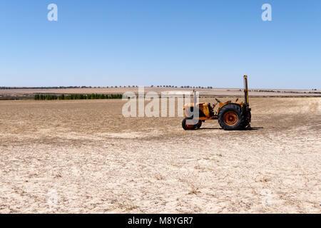 Old Champion tractor with post hole digger attached on Australian farmland, Western Australia Stock Photo