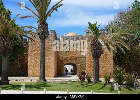 View of the entrance arch of the Governors Castle (Castelo dos Governadores) with palm trees in the foreground and tourists enjoying the setting, Lago Stock Photo