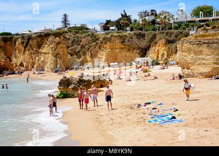 Tourists relaxing on Praia da Batata beach, Lagos, Algarve, Portugal, Europe. Stock Photo