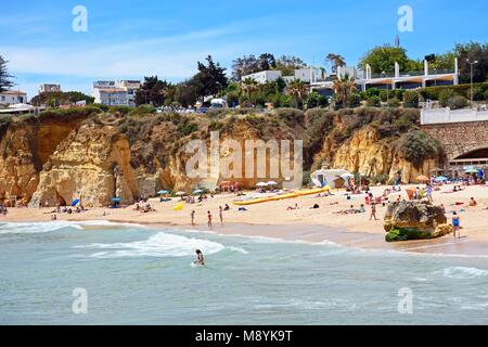 Tourists relaxing on Praia da Batata beach, Lagos, Algarve, Portugal, Europe. Stock Photo