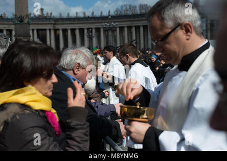 Vatican City. Faithfuls receive communion during the inauguration mass at St Peter's square on March 19, 2013 at the Vatican. Stock Photo