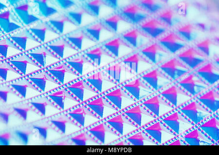 Holographic ultraviolet creative geometric background with selective focus. Foil with a holographic covering. Holographic background. Stock Photo
