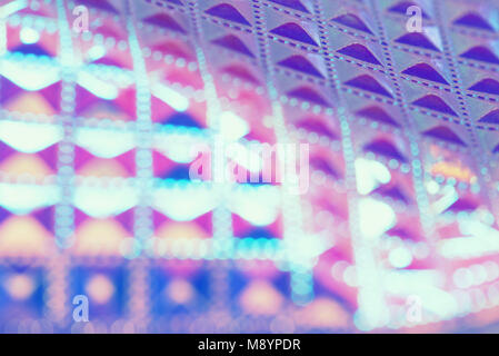 Holographic ultraviolet geometric background with selective focus. Foil with a holographic covering. Holographic background. 80s 90s fashion design.