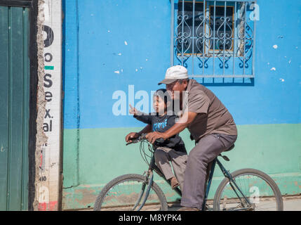 San Juan Teitipac, Oaxaca, Mexico - A man and a boy on a bicycle in a small Zapotec town. Stock Photo