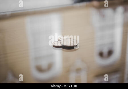 American 50 cents and two dimes / 10 cents coins on a shiny surface of a coffee shop ready for payment Stock Photo