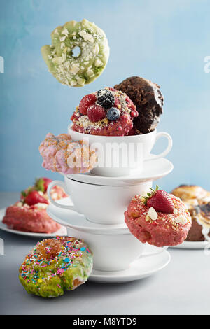 Variety of donuts in stacked cups Stock Photo